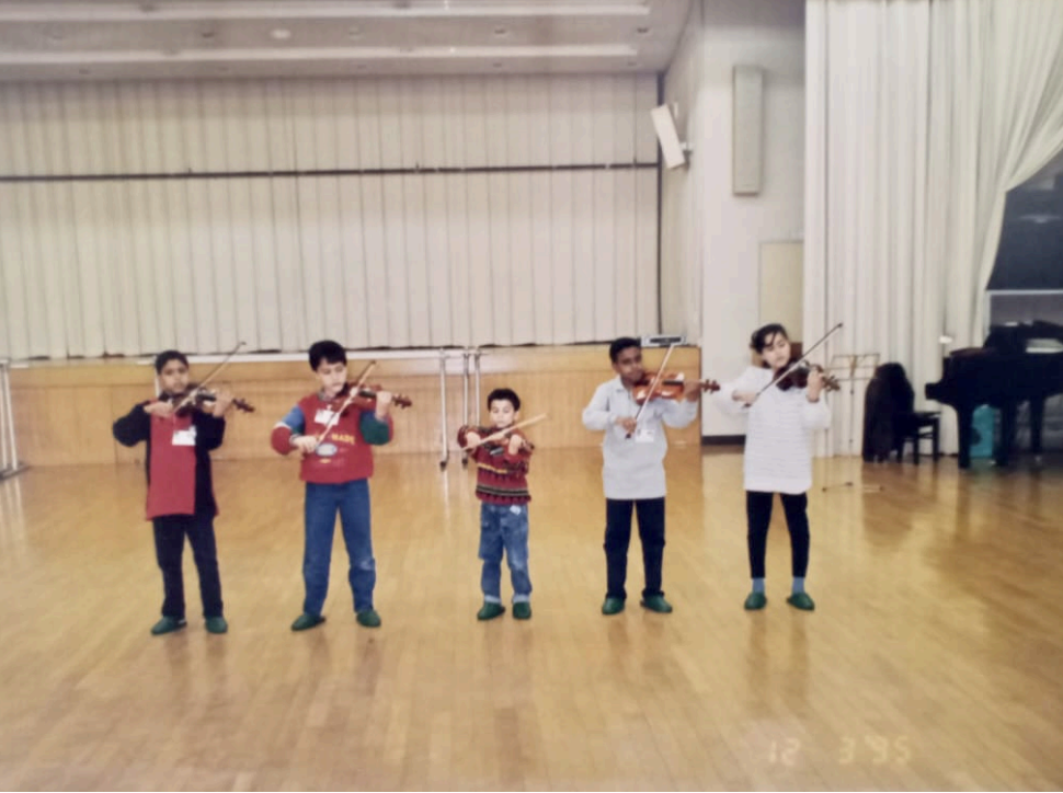 Five Egyptian Suzuki violin students of Dr Osman El Mahdy rehearsing in Tokyo before the concert. 1994